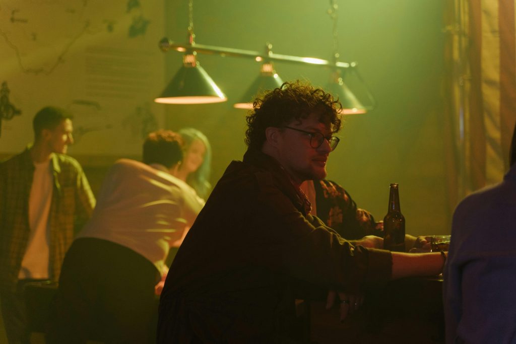 Friends enjoying drinks and conversation at a cozy bar.